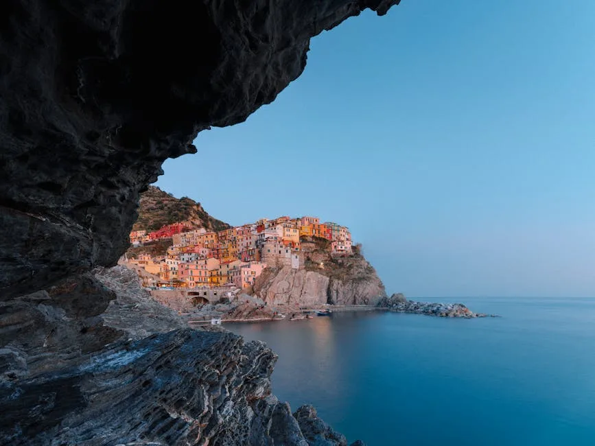 Village des Cinque Terre éclairé au crépuscule encadré par une cavité rocheuse