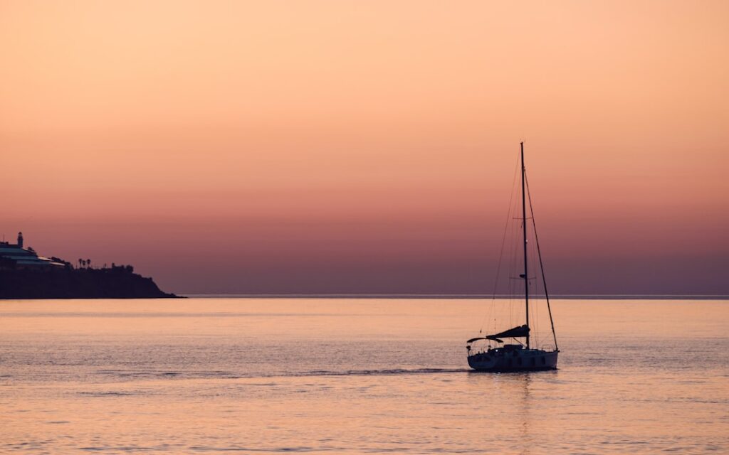 Couple enjoying sunset boat cruise Italian coast